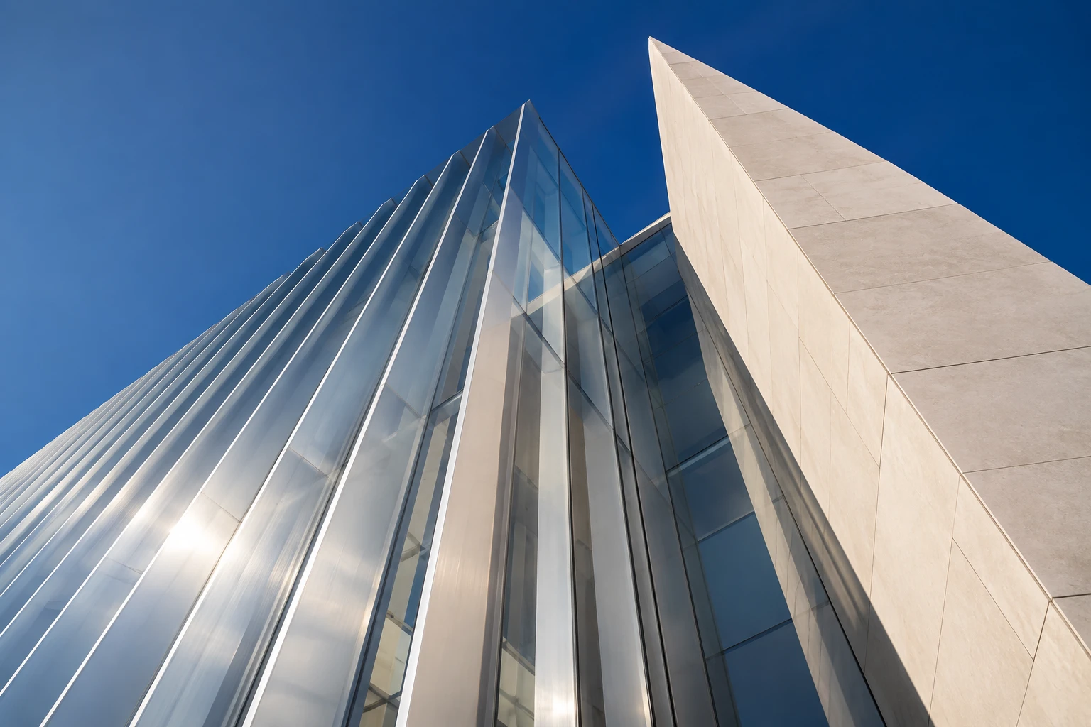 Light falling across sculptural glass and stone architecture